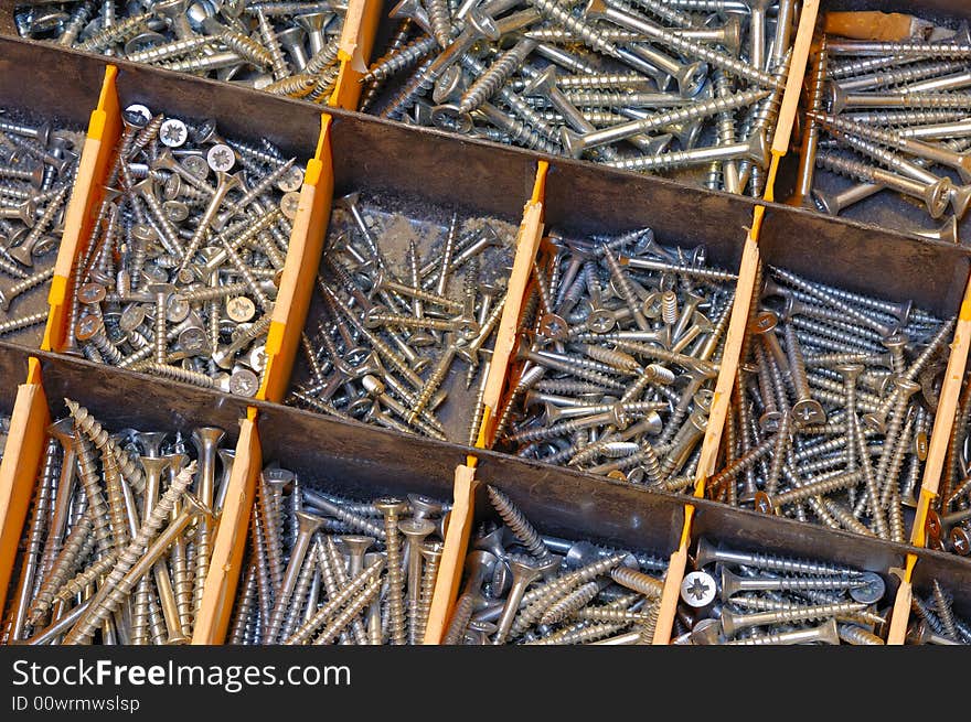 Close up of a selection of screws in a workman's toolbox