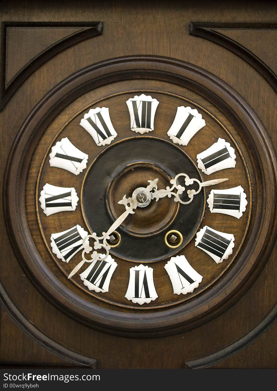 Old beauty and wooden brown wall clock. Old beauty and wooden brown wall clock.