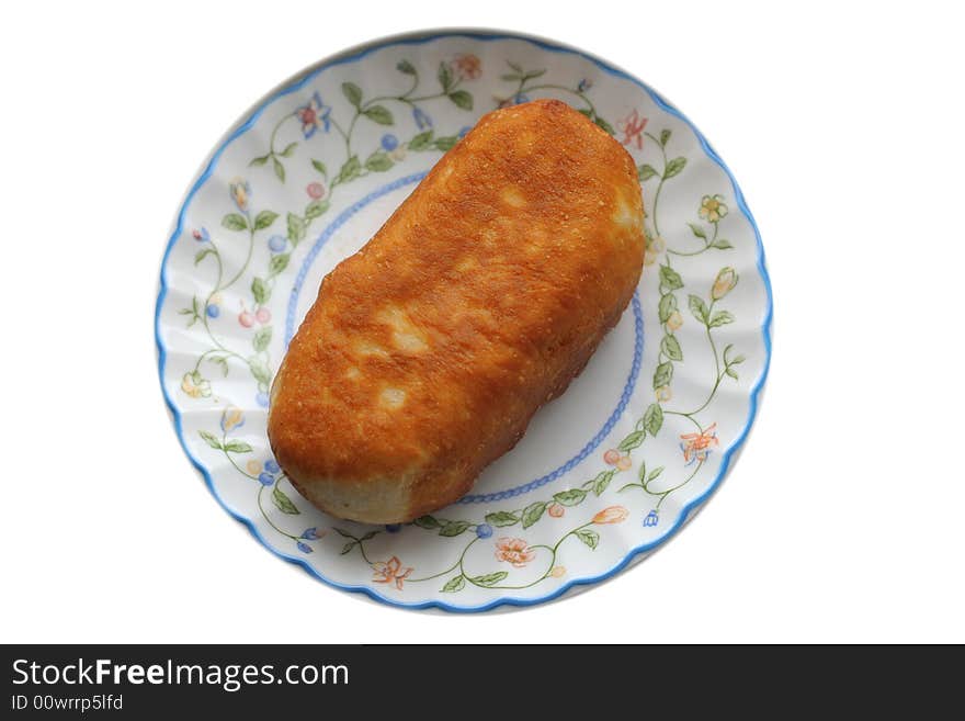 Roasted pie at plate  on a white background