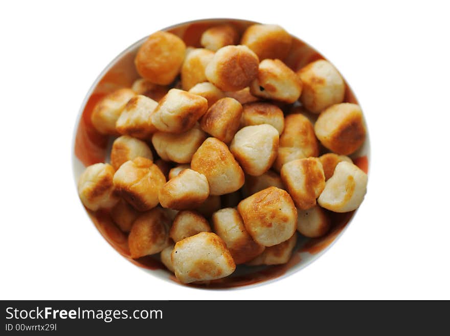 Roasted cookies at plate on a white background