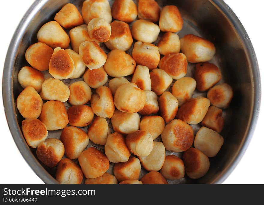 Roasted cookies at steel plate on a white background