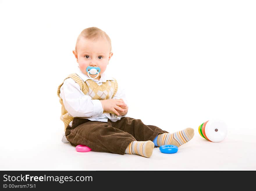 Small boy with pacifier plays on the floor. Small boy with pacifier plays on the floor