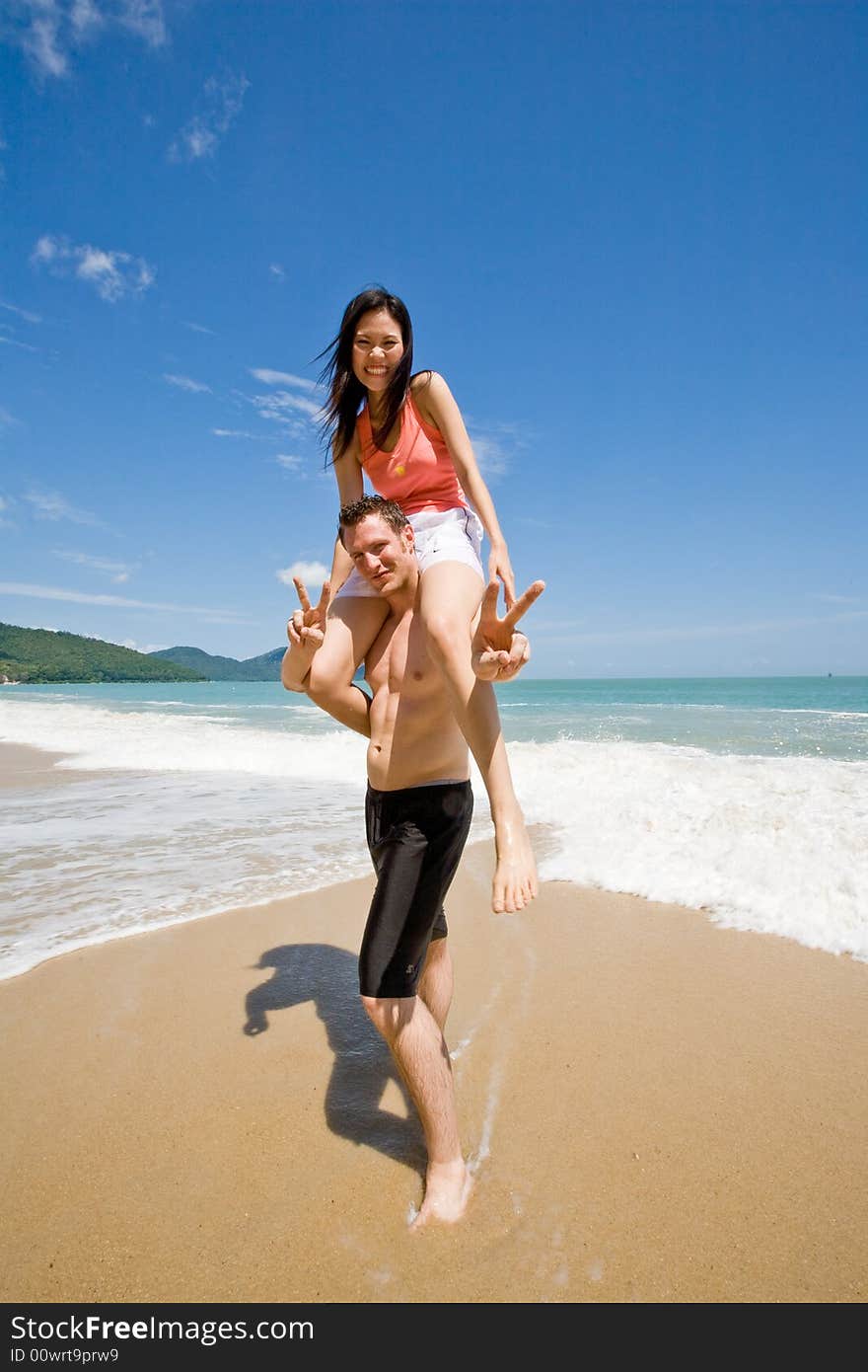 A happy couple having lots of fun at the beach. A happy couple having lots of fun at the beach