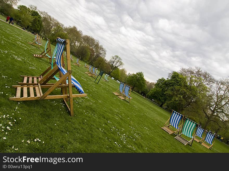 Empty deck chairs under impressive cloudscape