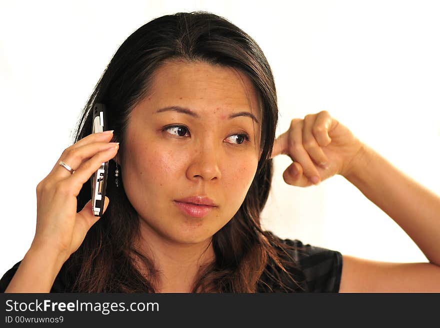 A young women occupied on a phone. A young women occupied on a phone