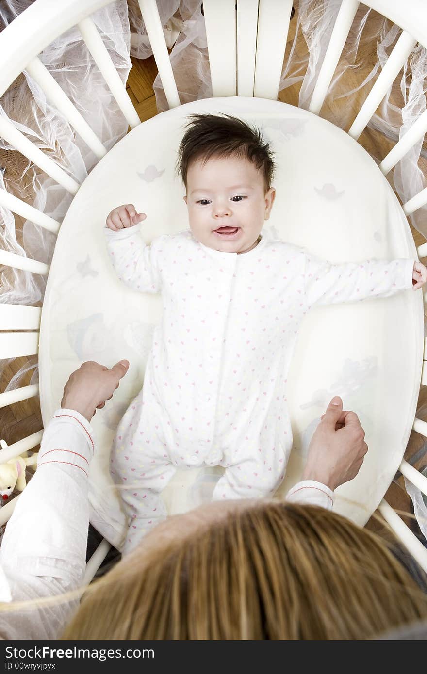 Sweet little baby smiling at her mother