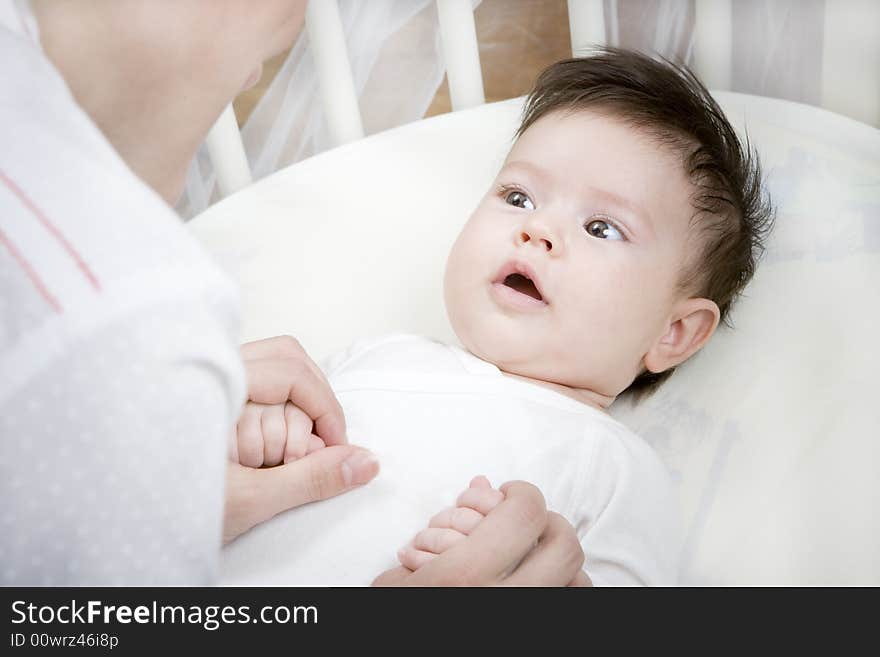 Sweet little baby looking at her mother