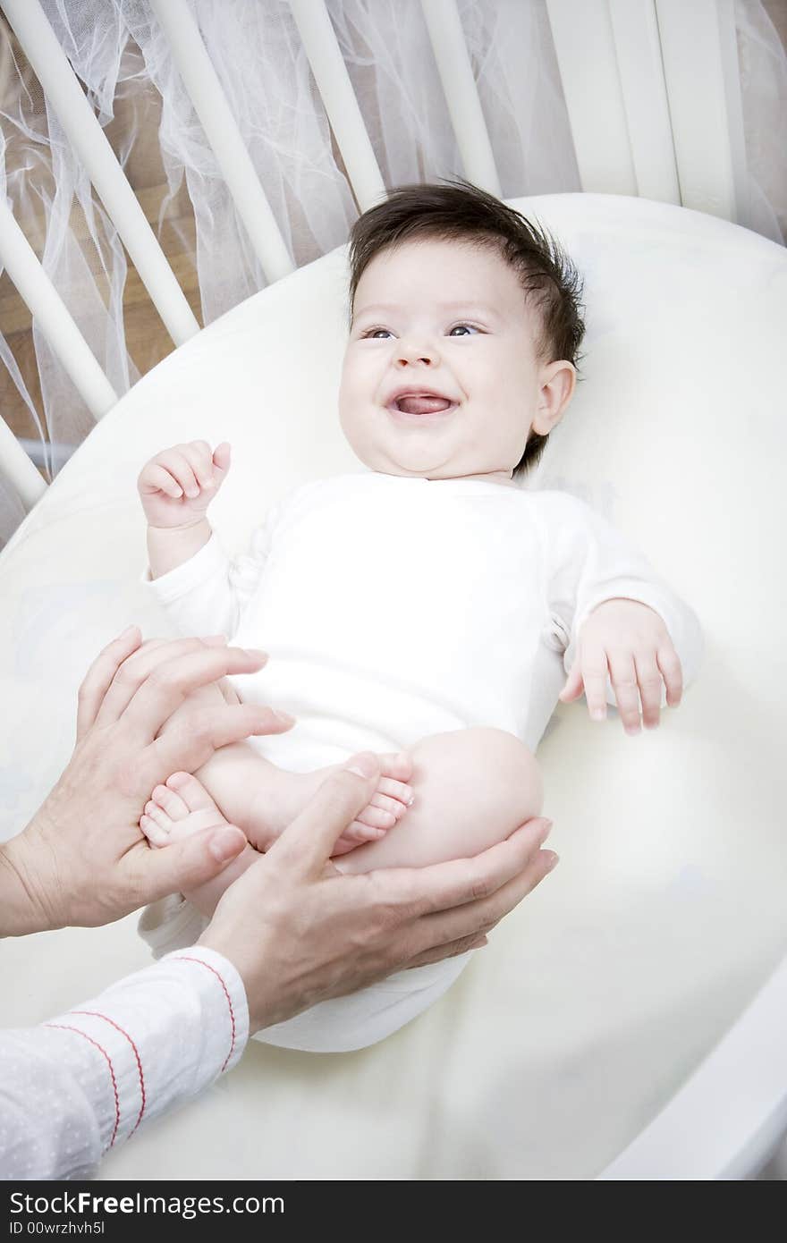 Sweet little baby smiling in her bed