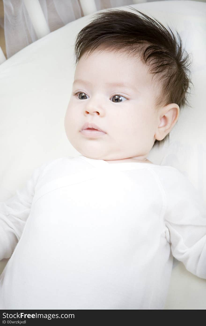 Sweet little baby laying in the bed