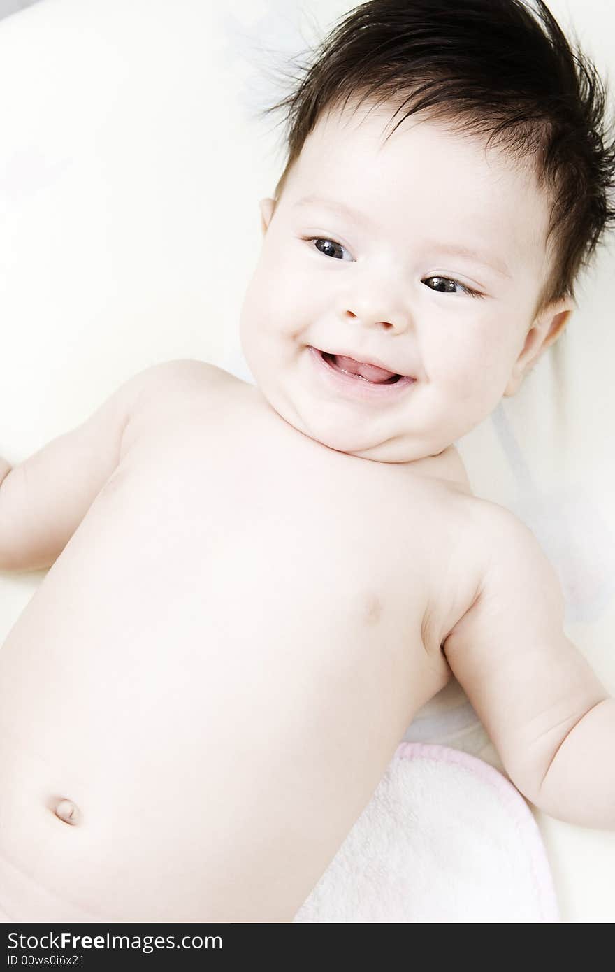 Sweet little baby smiling in her bed