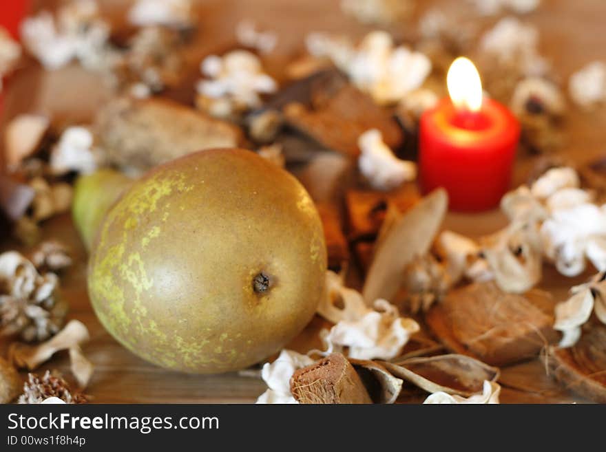 Burning candle, Pear and Dried Plants