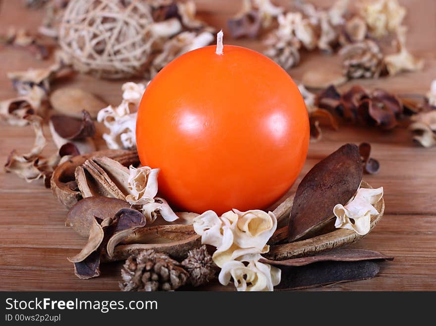 Orange candle and dried plants