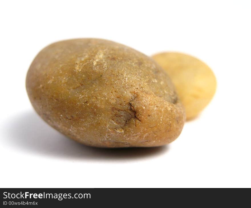 Two yellow stones on a white background