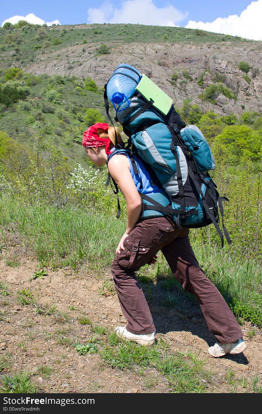 Girl with backpack hiking in mountains. Girl with backpack hiking in mountains