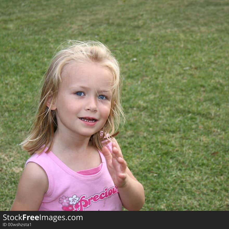 A beautiful white caucasian girl child in the garden. A beautiful white caucasian girl child in the garden