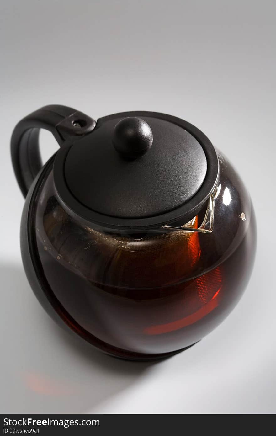 Strong black tea in a fashionable teapot