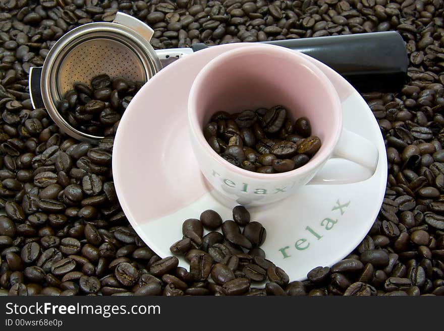 Coffee beans with cup and saucer