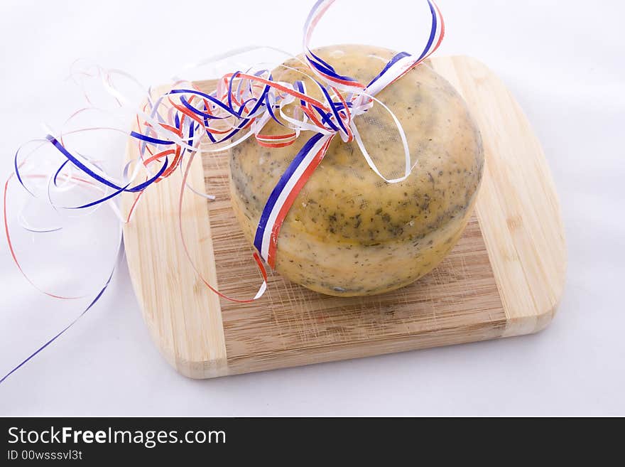 Single traditional Dutch cheese on a kitchen board