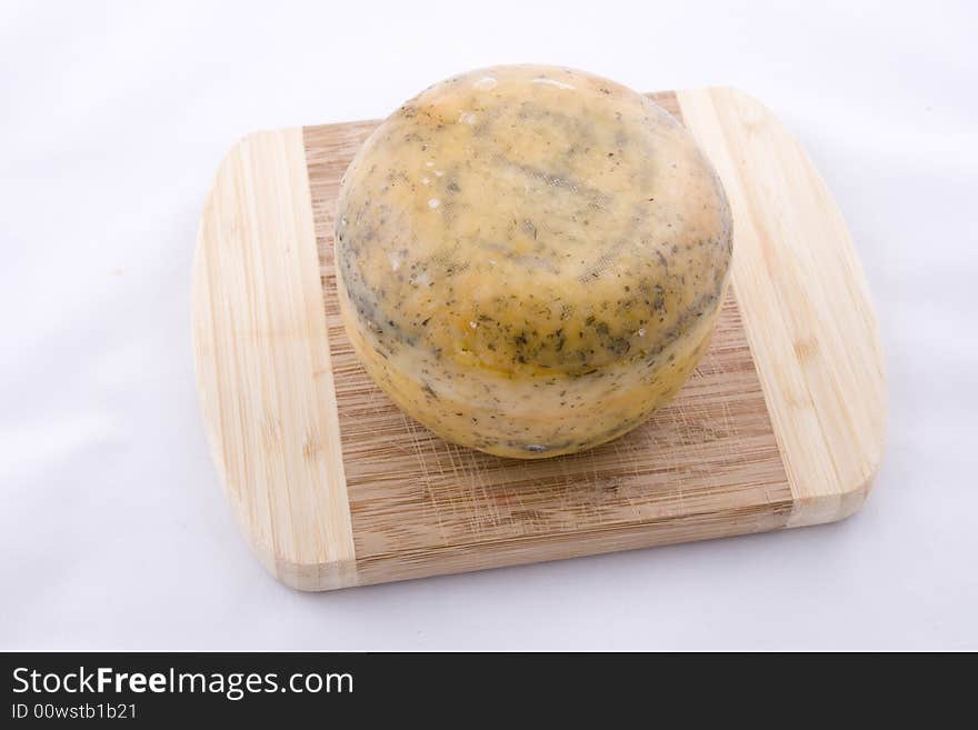 Single traditional Dutch cheese on a kitchen board