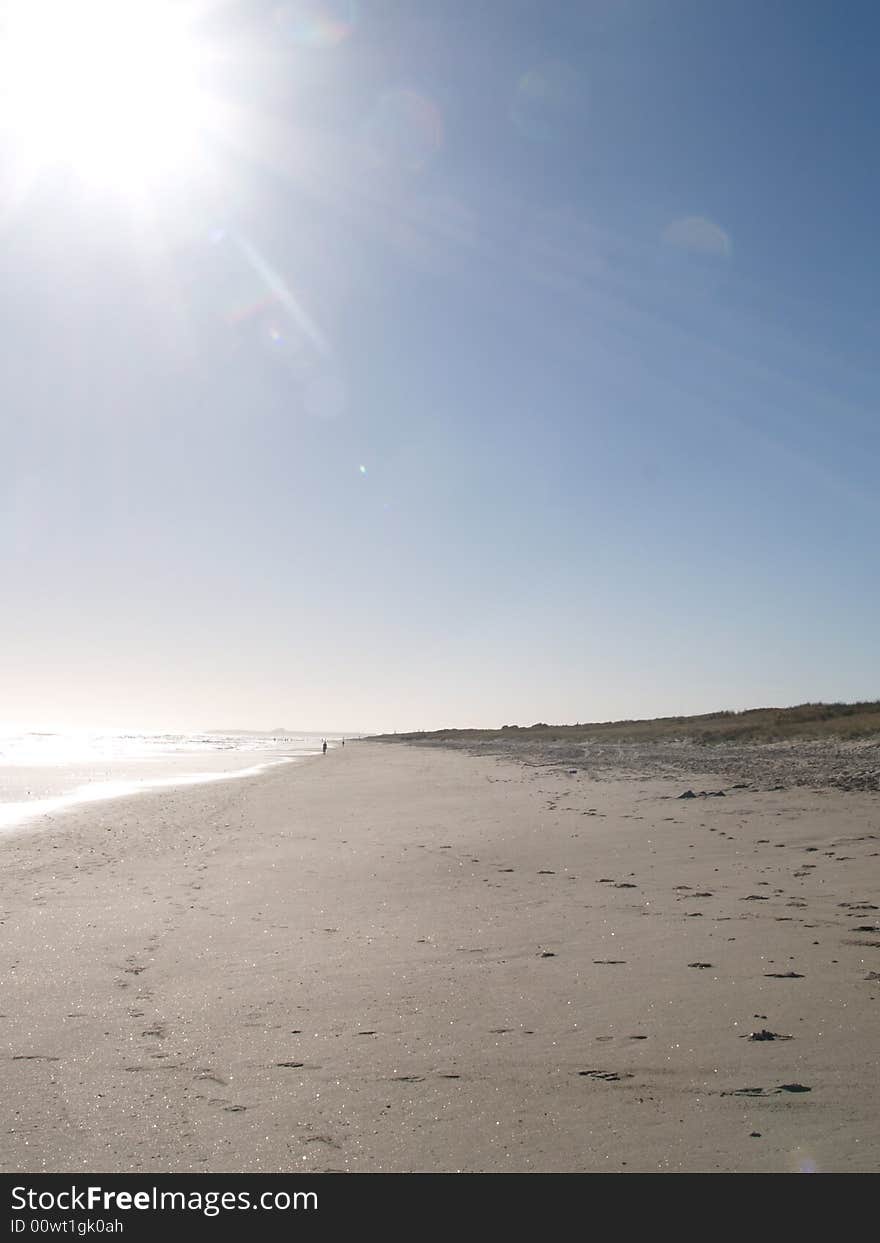 Almost empty beach drenched in bright sunlight. Almost empty beach drenched in bright sunlight.