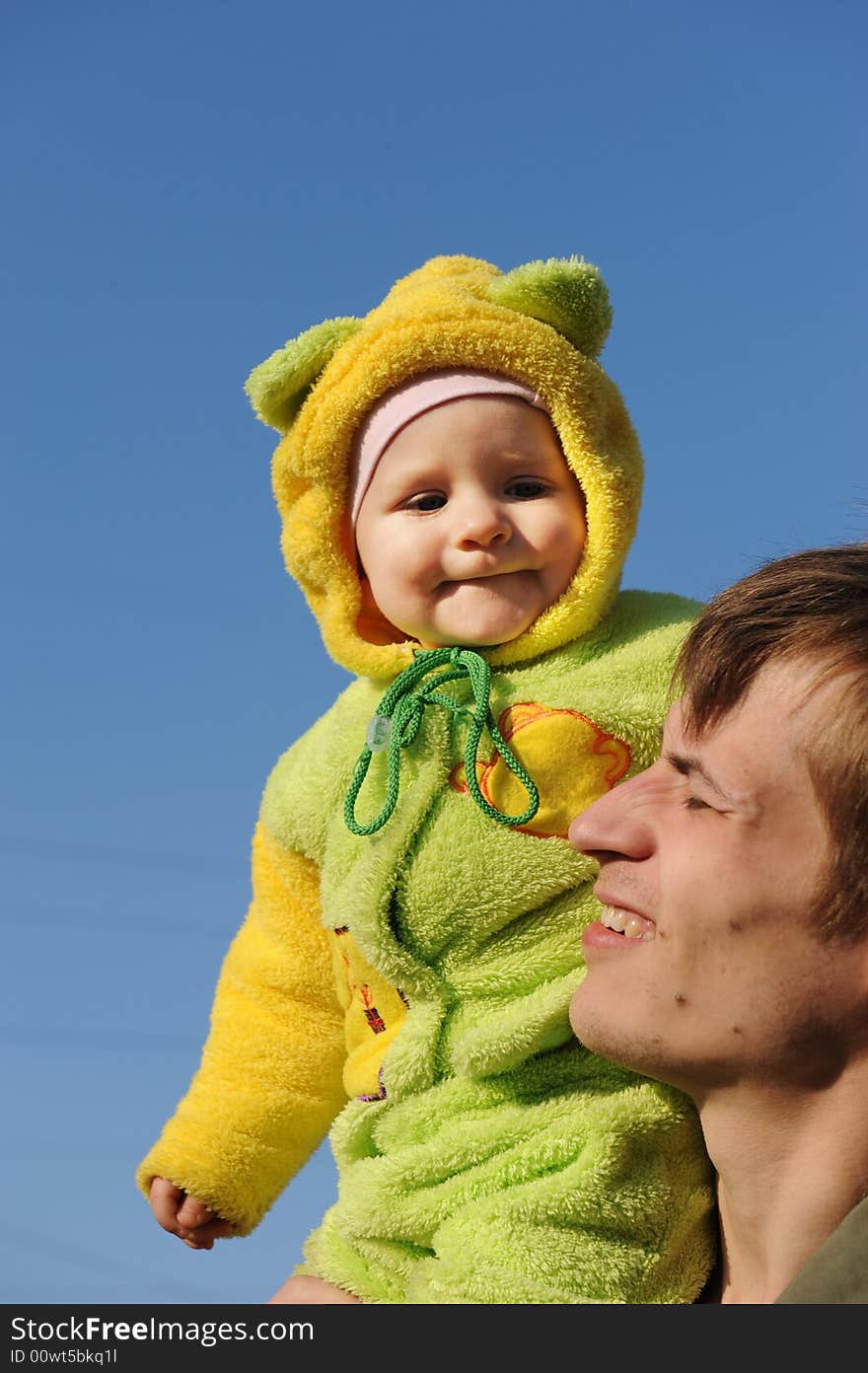 Happy father and daughter on a blue sky