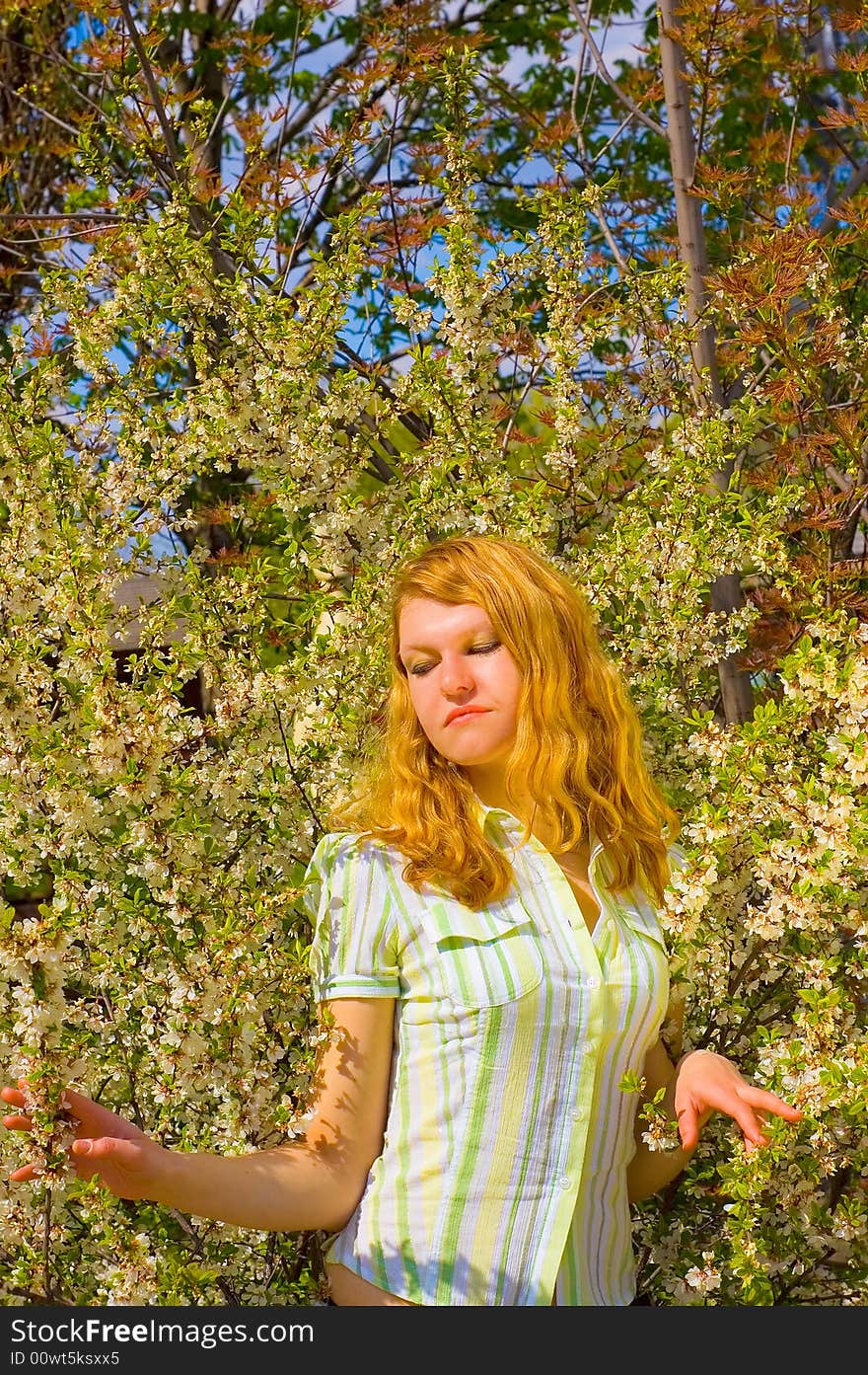 Girl near yellow flowers tree