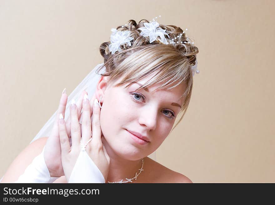 Bride putting on ear-ring