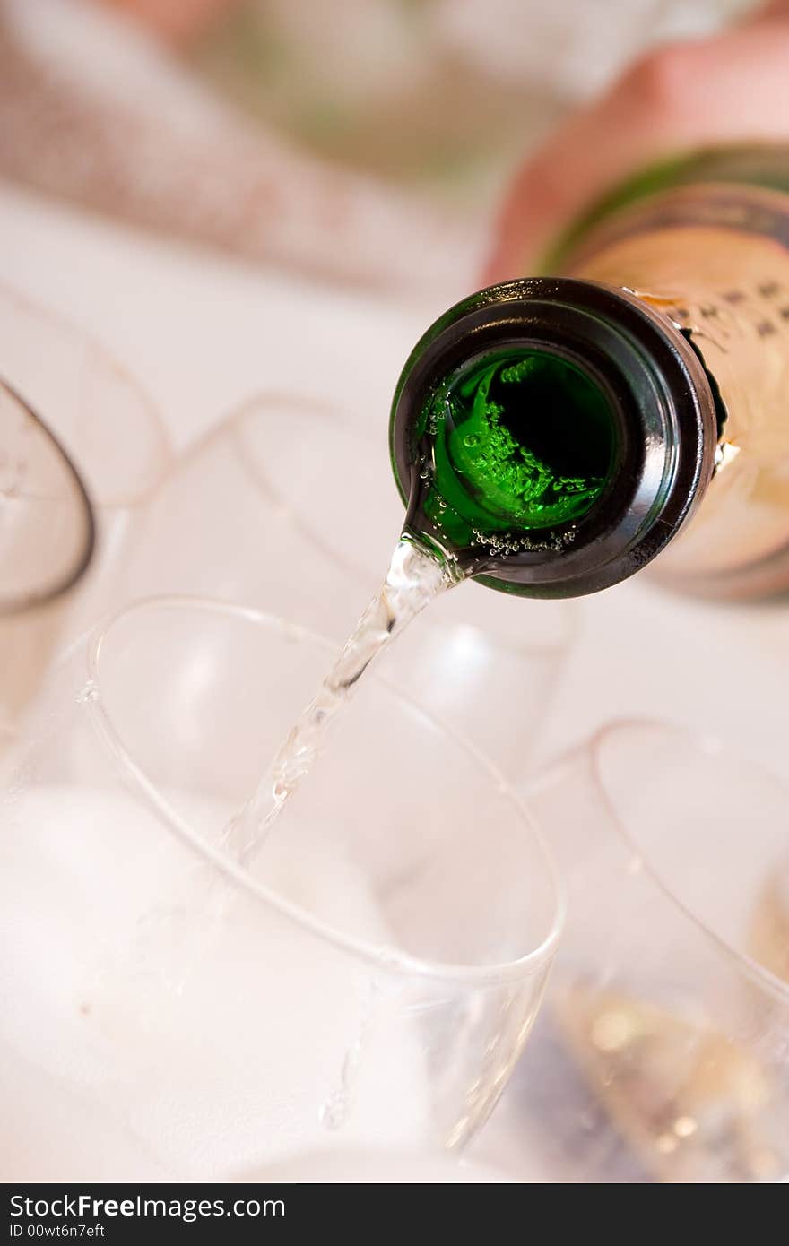 Pouring of champagne to the glasses