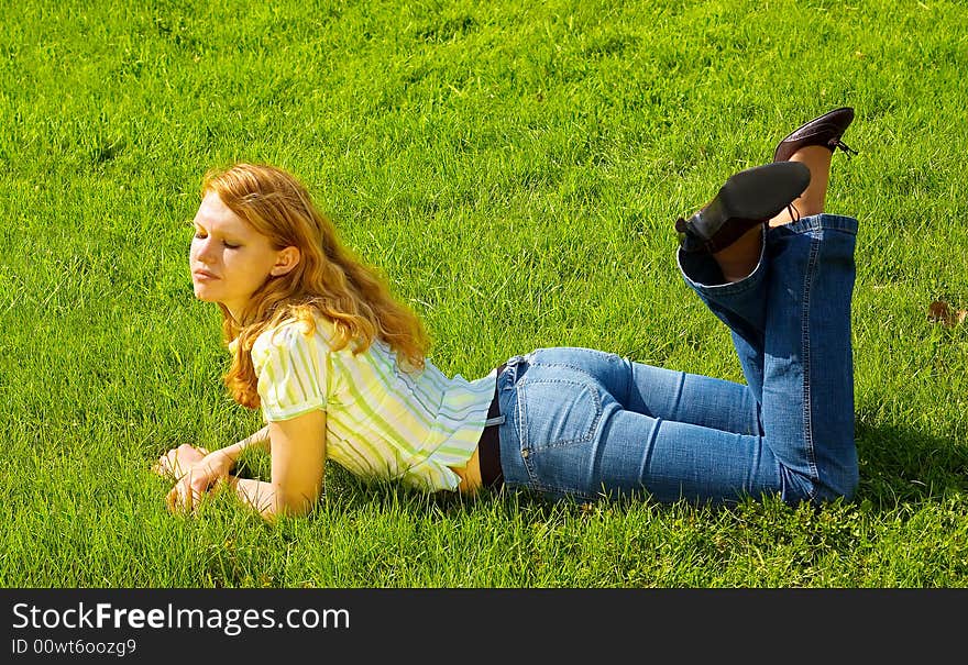 Girl Is Relaxing On The Grass