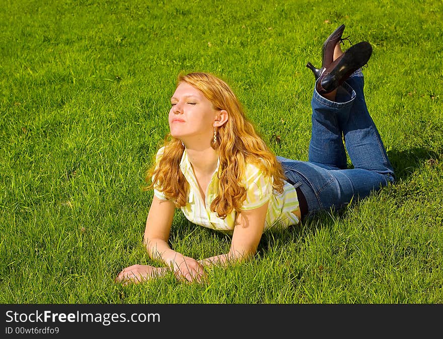 Girl is relaxing on the grass