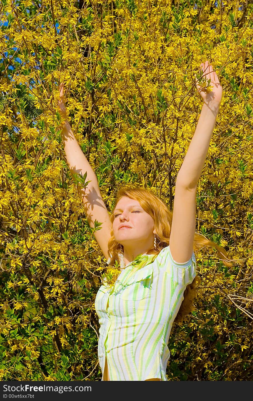 Girl near yellow flowers tree