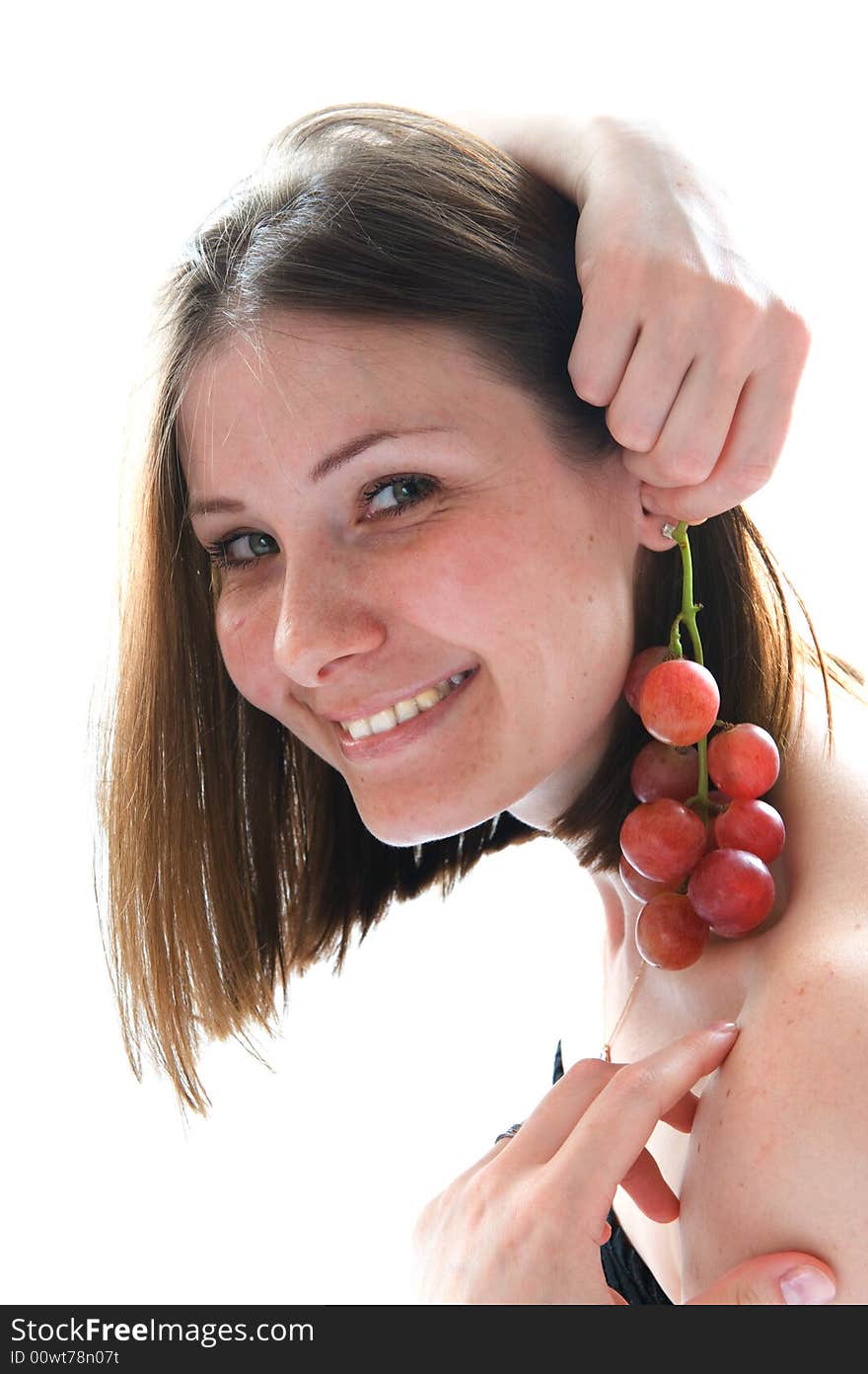 Beautiful young woman with red grape. Isolated