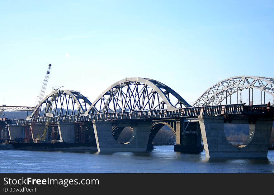 Railway bridges in the southern part of Kiev, Ukraine. Photo taken from the left bank of the Dnieper river. Railway bridges in the southern part of Kiev, Ukraine. Photo taken from the left bank of the Dnieper river.