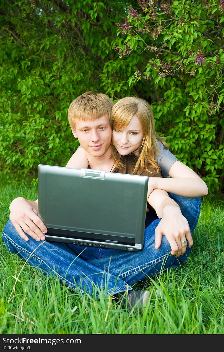 Young couple with laptop outdoors. Young couple with laptop outdoors