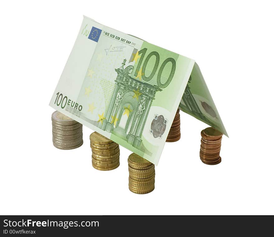 Closeup of a gable roof made from hundred Euro banknotes over coin pillars, isolated on white.  Clipping path saved.