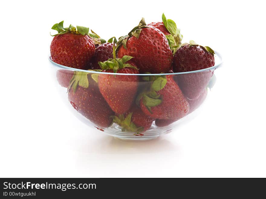 Red ripe strawberries in a glass cup