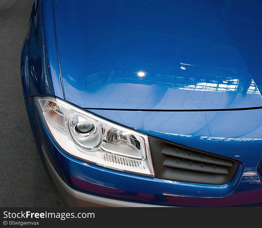 Modern blue car (front view) on the flor. Modern blue car (front view) on the flor