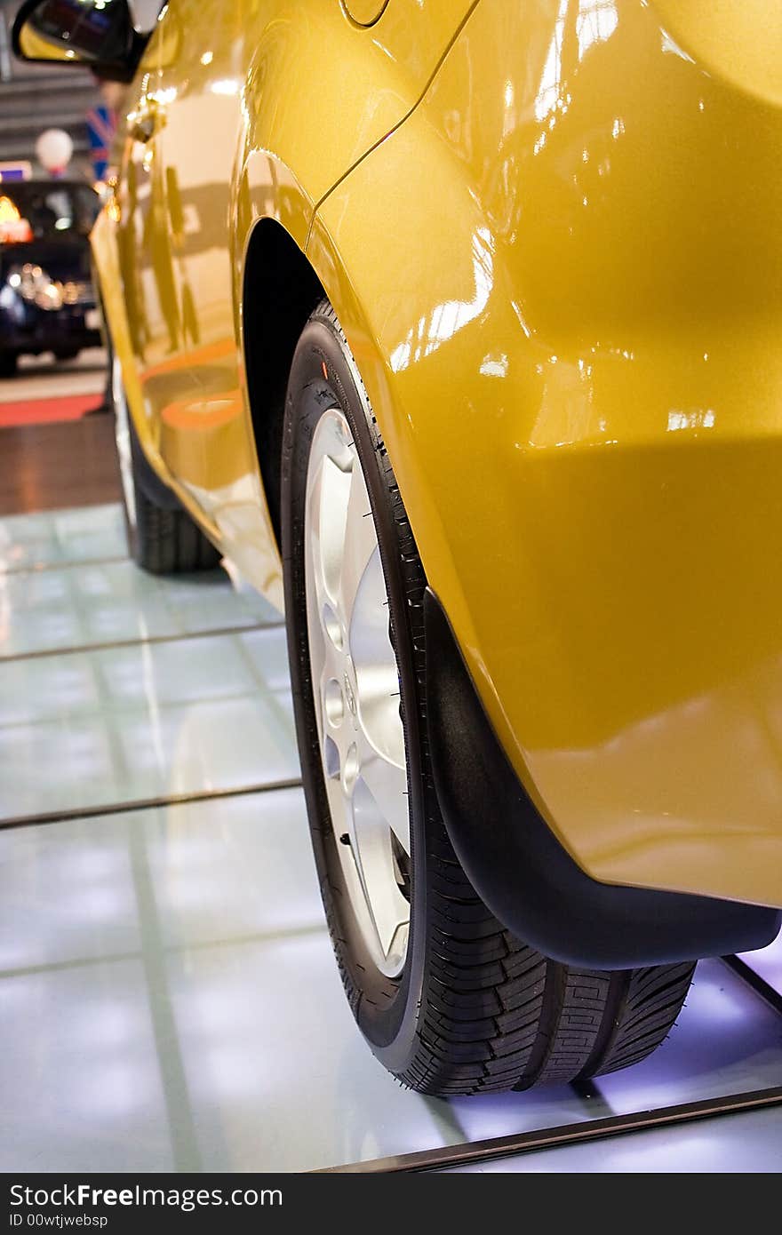 Modern small yellow car (back view) on the flor. Modern small yellow car (back view) on the flor