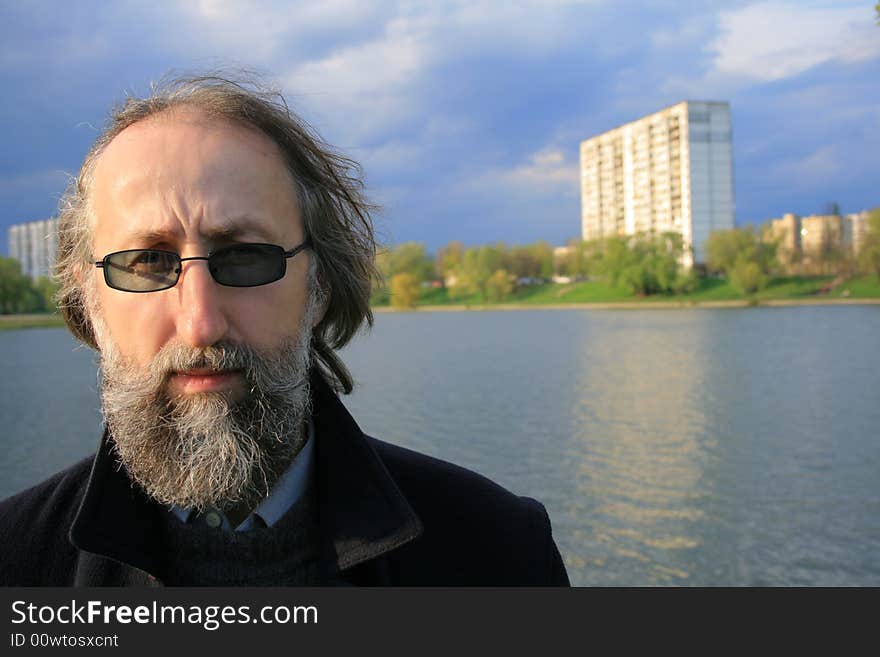 An adult man during walk around the lake. An adult man during walk around the lake