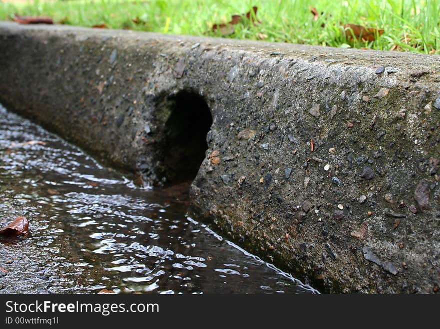 Water draining into a gutter. Water draining into a gutter