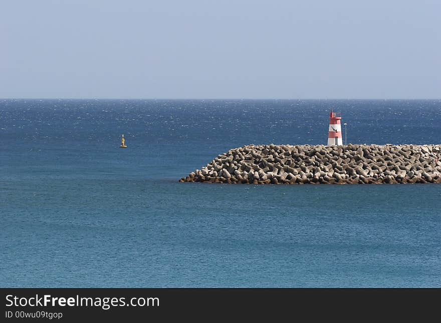 Little lightouse at an harbor entrance