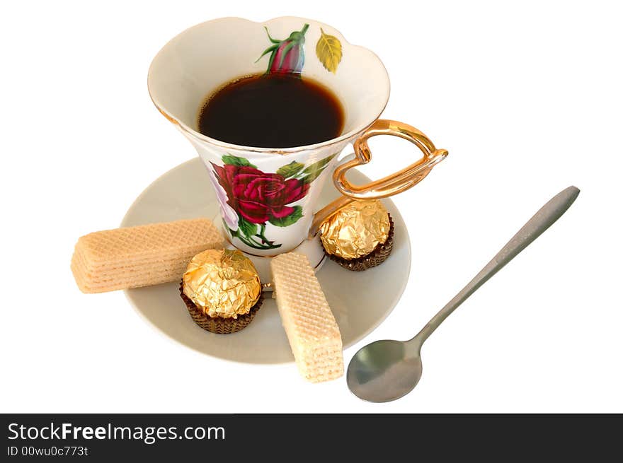 Old china cup of tea (or coffee) and sweeties on isolated background. Old china cup of tea (or coffee) and sweeties on isolated background.