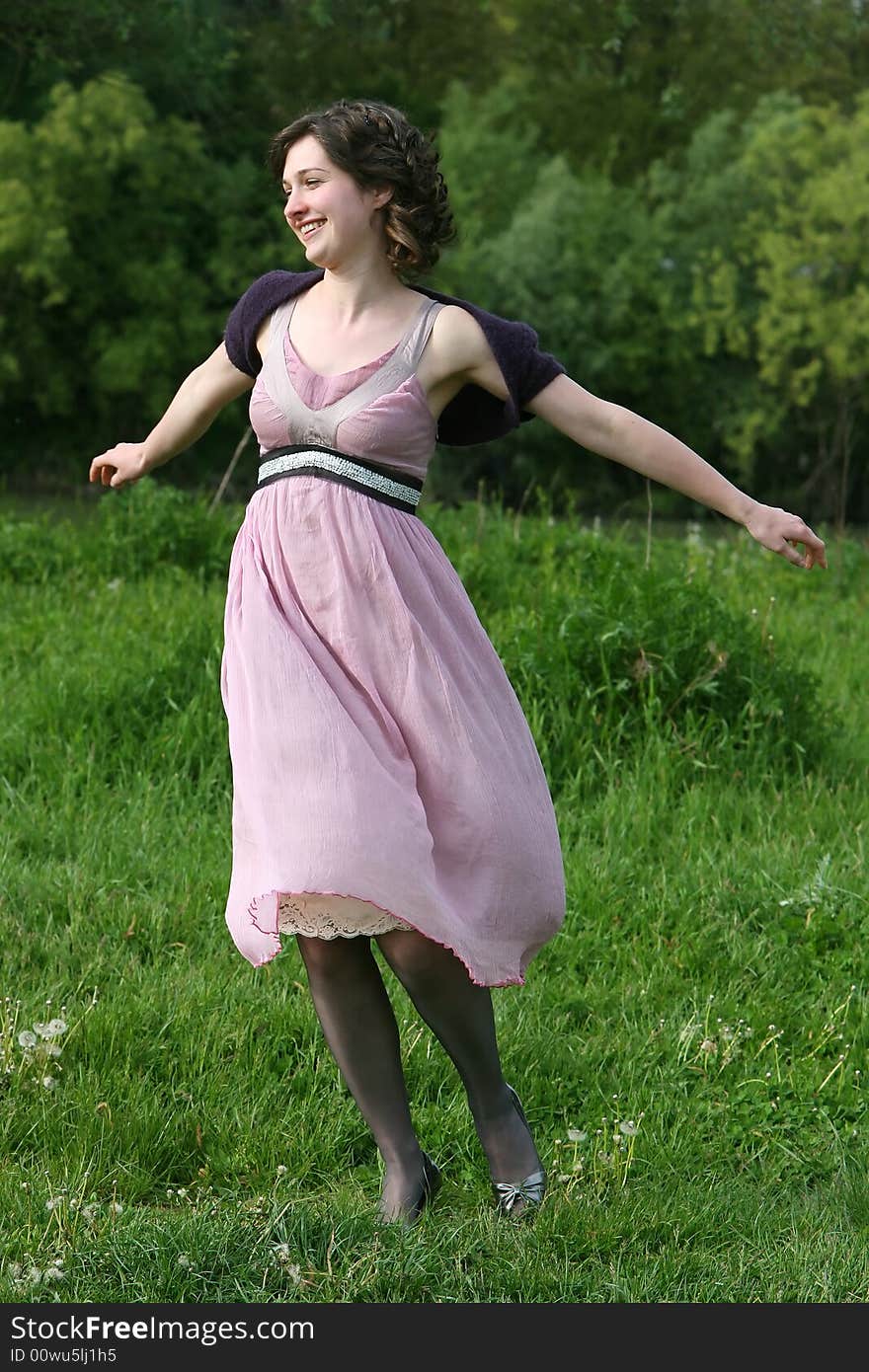 Woman jumping with joy on a green field. Woman jumping with joy on a green field