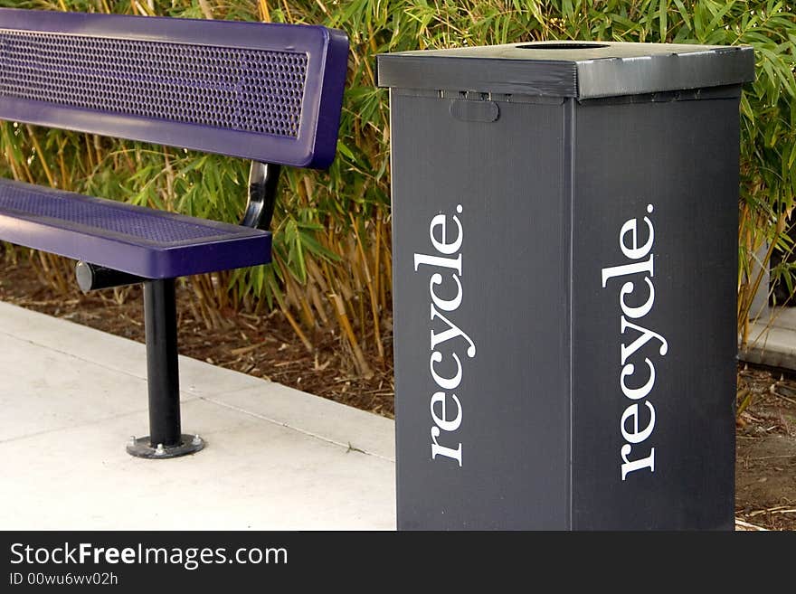 Purple park bench and a black cardboard recycle box. Purple park bench and a black cardboard recycle box.