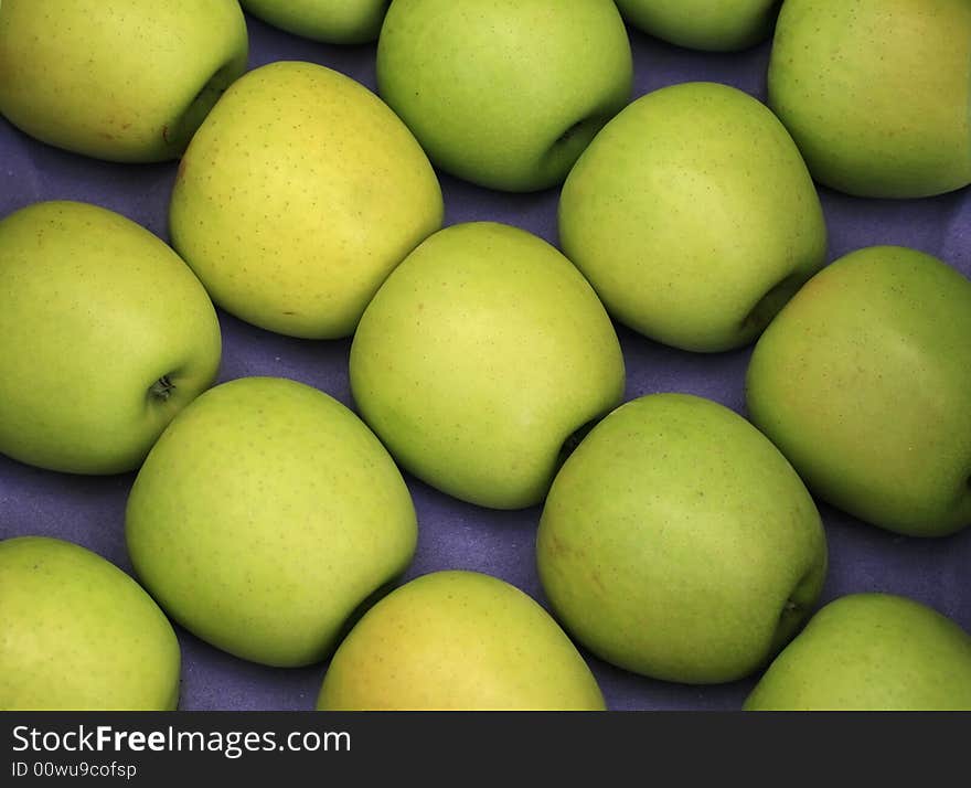 Green apples on a blue background