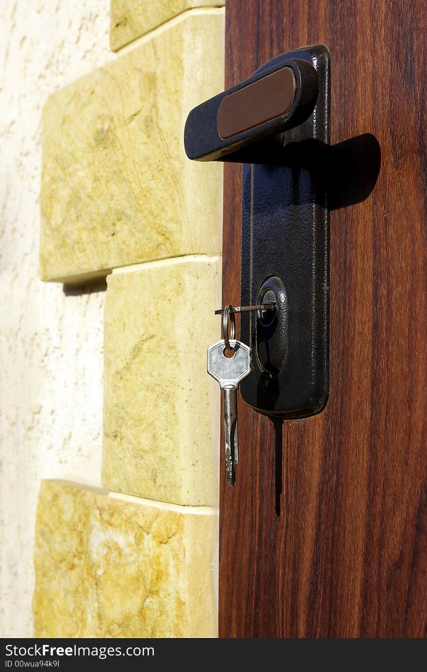 A hotel room door lock and key.