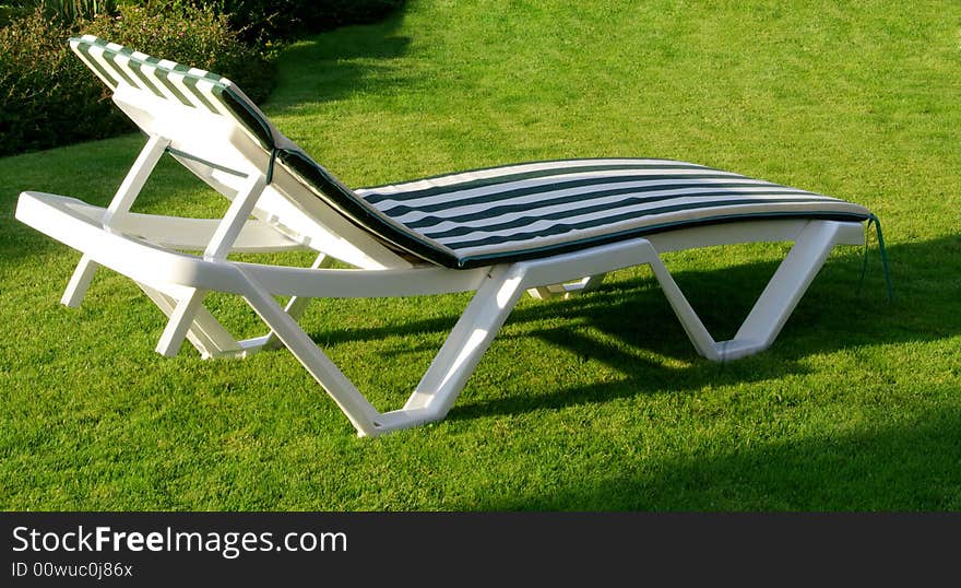 Stove-bench in a green garden on a grass