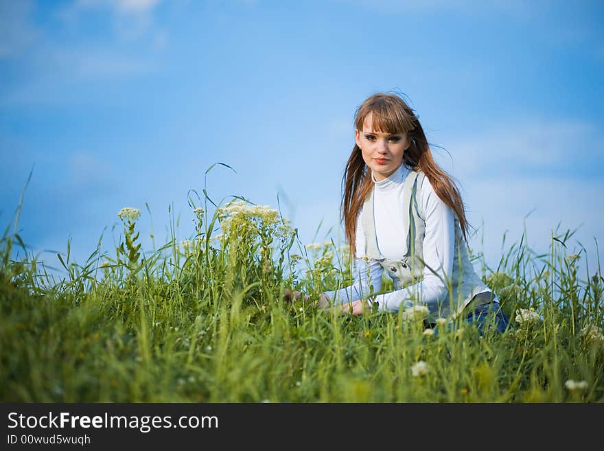 Young cute girl resting at green grass in spring. Young cute girl resting at green grass in spring