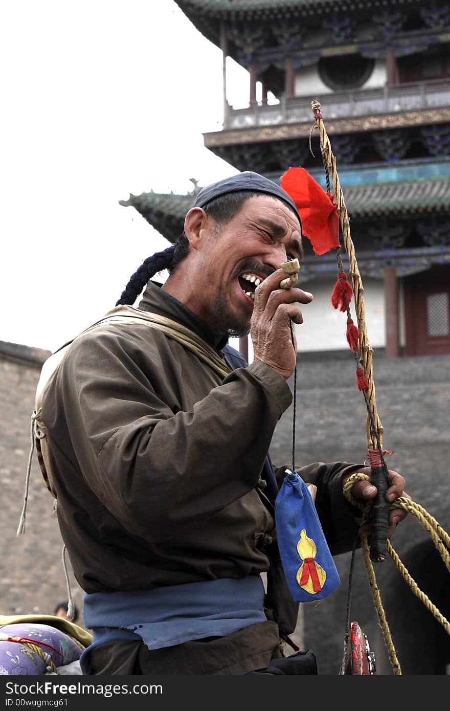 In Chinese Pingyao of ancient city, a peddler doing business outside has made money, ride a donkey, moan the ditty, walks to the family very cheerfully. Such dressing is still the dressing in Qing Dynasty before over one hundred years,there is no such a pedlar today, just the performer's professional performance, in order to attract tourists. In Chinese Pingyao of ancient city, a peddler doing business outside has made money, ride a donkey, moan the ditty, walks to the family very cheerfully. Such dressing is still the dressing in Qing Dynasty before over one hundred years,there is no such a pedlar today, just the performer's professional performance, in order to attract tourists.