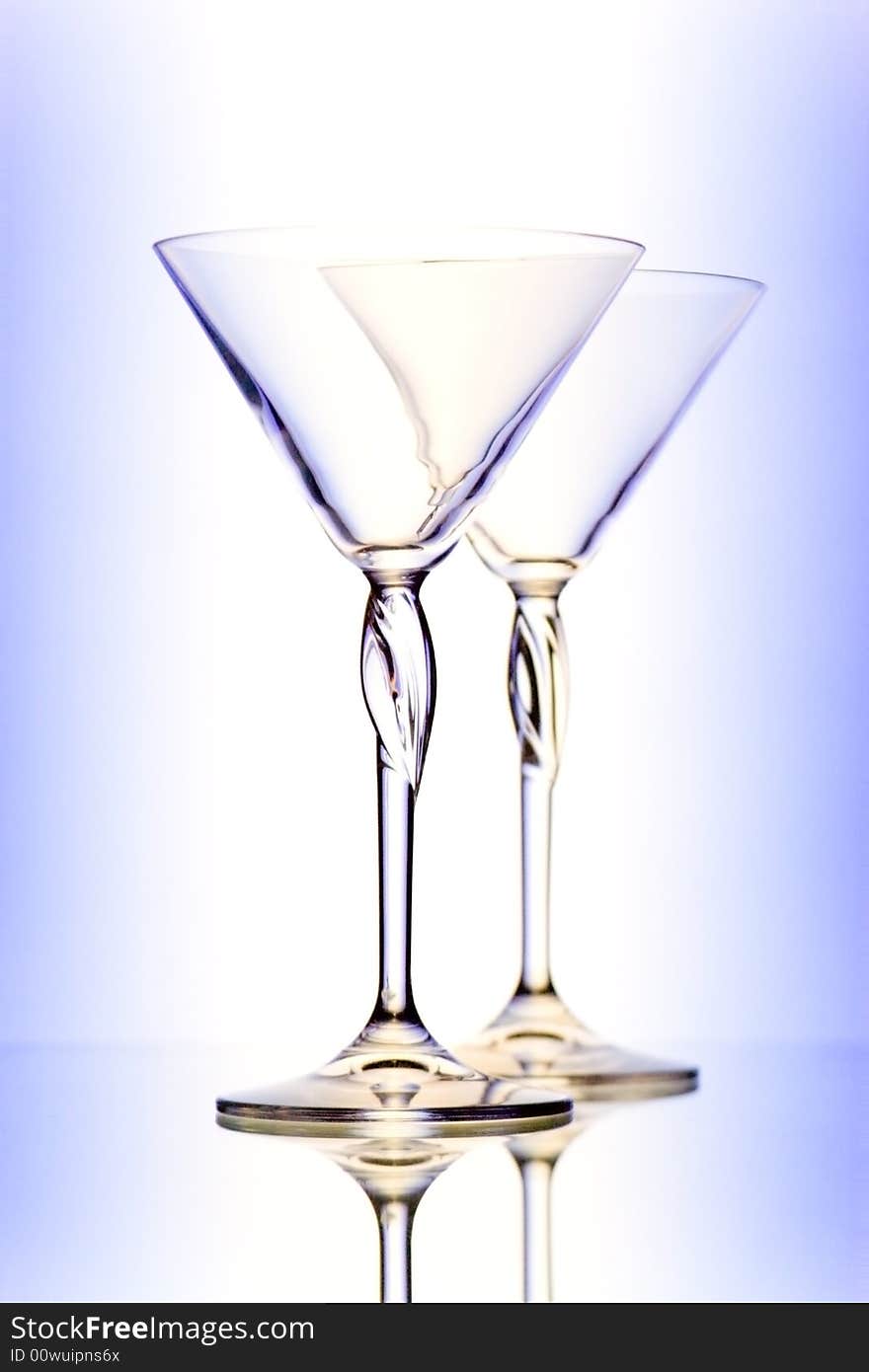 Two glasses for martini on gradient background